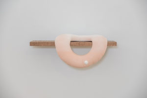 Media includes cast porcelain, glaze, flocking, oak.