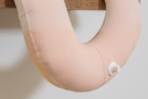 Media includes cast porcelain, glaze, flocking, oak.