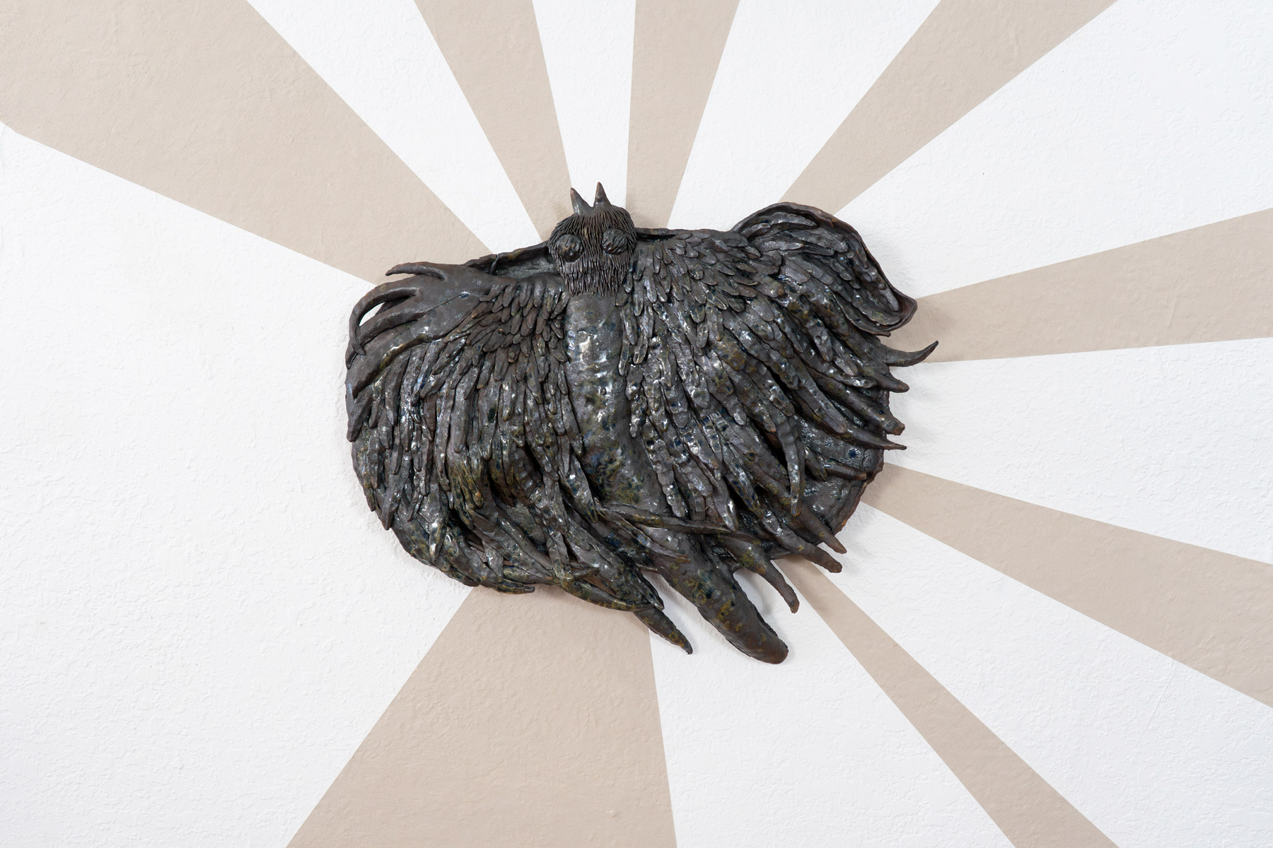 Behind these wall pieces are unfired slip, made from the same clay as the sculptures. As the exhibition went on, the slip slowly cracked. The beams symbolize the joy and hope these prairie inspired creatures giving me. The cracking brings a reality of trying to sustain this hope in an often harrowing world.