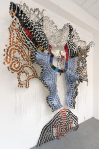 Recycled materials (plastic, aluminum coffee capsules and wine bottle seals), copper staples, copper wire