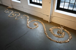 Liminal Spaces references life transitions and life cycles using an ancient Celtic symbol and elements in nature that exist within natural environments. For this recent installation, I began with raw materials to create a design reminiscent of a labyrinth; a sacred place to reflect and center oneself in the midst of chaos. The desert spirals were created with bits from a previous installation using sand, dirt and collected bits of debris from the Sonoran Desert in Phoenix. I used ceramic techniques to preserve some bits by dipping them in clay slip, coating with crawl glazes and firing them in a kiln. Some were fired numerous times, others only once. Other bits were coated in chalk and milk paint, and some were left raw.