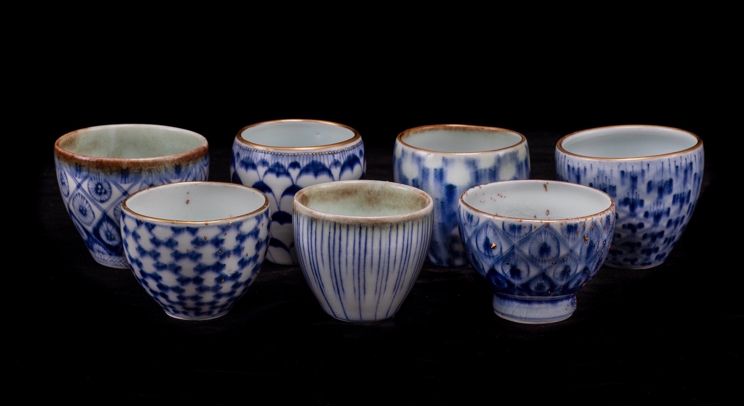 This work features celadon glaze and  Kiangxi quinhua - Jingdezhen under-glaze blue and white - and 24 k Roman gold. These pieces utilize a runny celadon glaze gas reduction fired, and re-firing at low temperature for gold and enamel applications. Gold nuggets are stoneware clay fragments with gold applications.