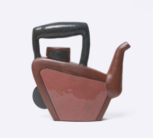 The spout is wheelthrown, attached to a slab built/handbuilt body. Most of it is unglazed with terra sigilata. There is a portion that is glazed mauve with a black inlayed line surrounding it. Cone 1.
