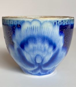 This intensity of color on this piece derives from premium Kiangxi Jingdezhen quinhua and 24k Roman gold. It is gas reduction fired to cone 10 celadon glaze and re-fired at low temperature for gold application.