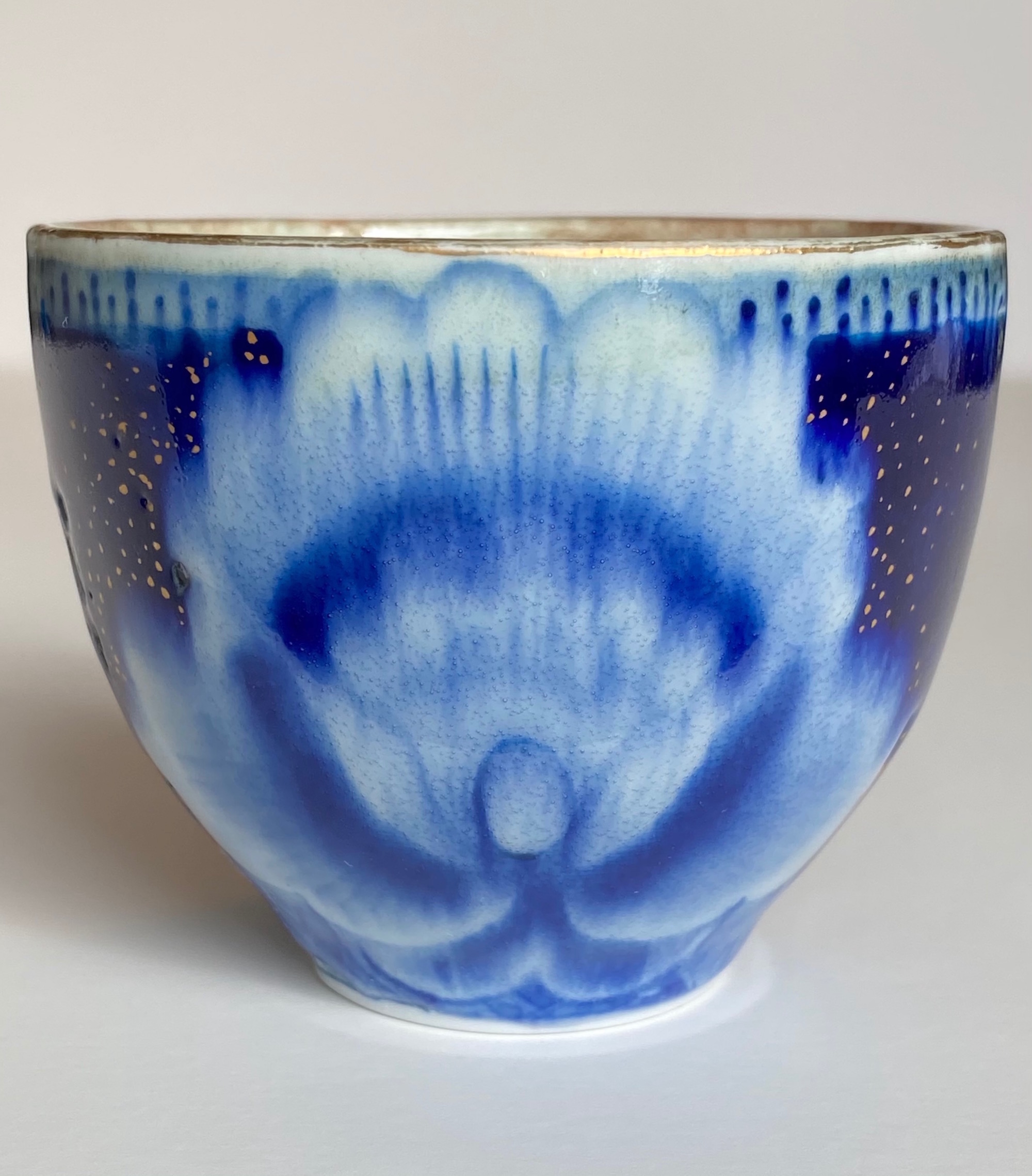 This intensity of color on this piece derives from premium Kiangxi Jingdezhen quinhua and 24k Roman gold. It is gas reduction fired to cone 10 celadon glaze and re-fired at low temperature for gold application.