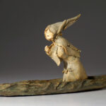 Little figure with a hat on a boat