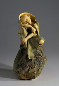 Young monk resting on a rock