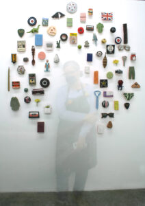 small representational objects in a halo on a white wall