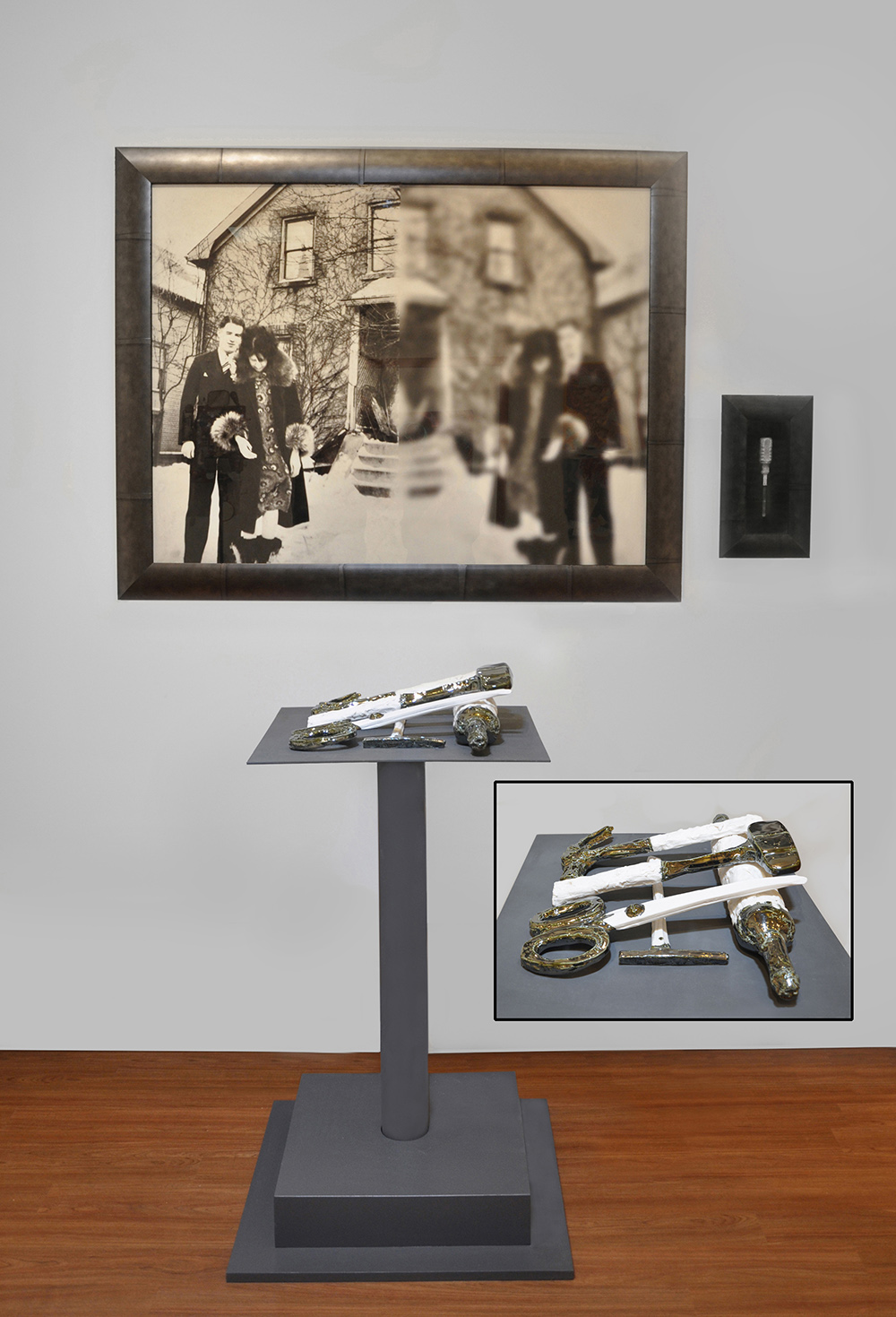 This installation includes : 5 porcelain pieces,  altered and framed archival photograph, framed screwdriver and metal pedestal. My grandmother Elsie married a drunk. These porcelain tools represent everyday household items she used to keep her husband at bay and her children safe. The photo is of her and her husband - the clear side represents her sharp vision while the blurred represents his. The small framed tool was original to Elsie.