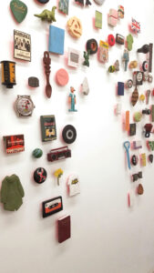 small representational objects in a halo on a white wall (detail)