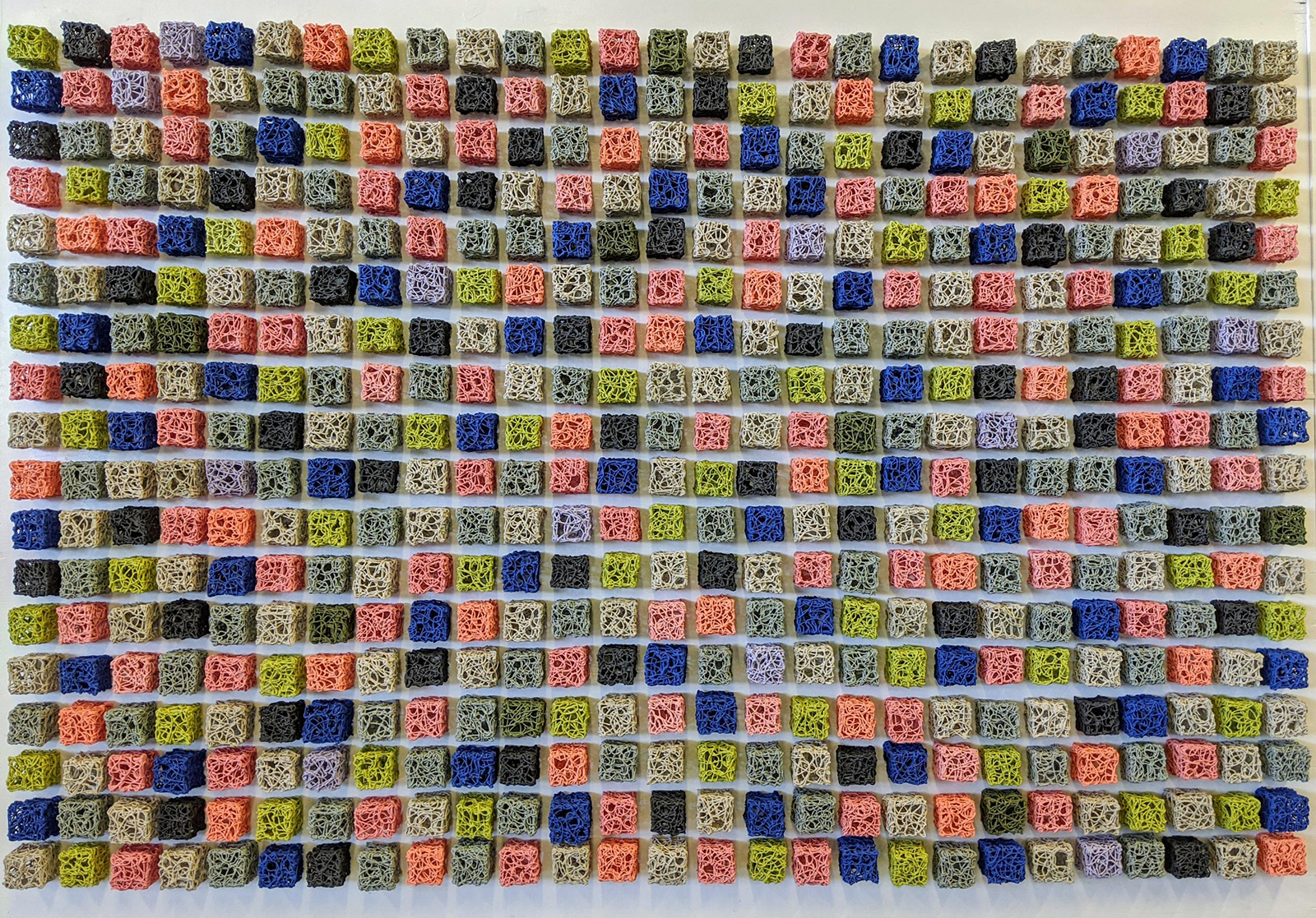 My work seeks to give form to time. This is a representation of the 57 days I spent as a visiting artist at Belger Crane Yard Studios in Kansas City, MO. Like a clock on the wall, this installation is hung exactly where we usually view time. Each cube takes ten minutes to make. You are viewing 4,860 hours of time.