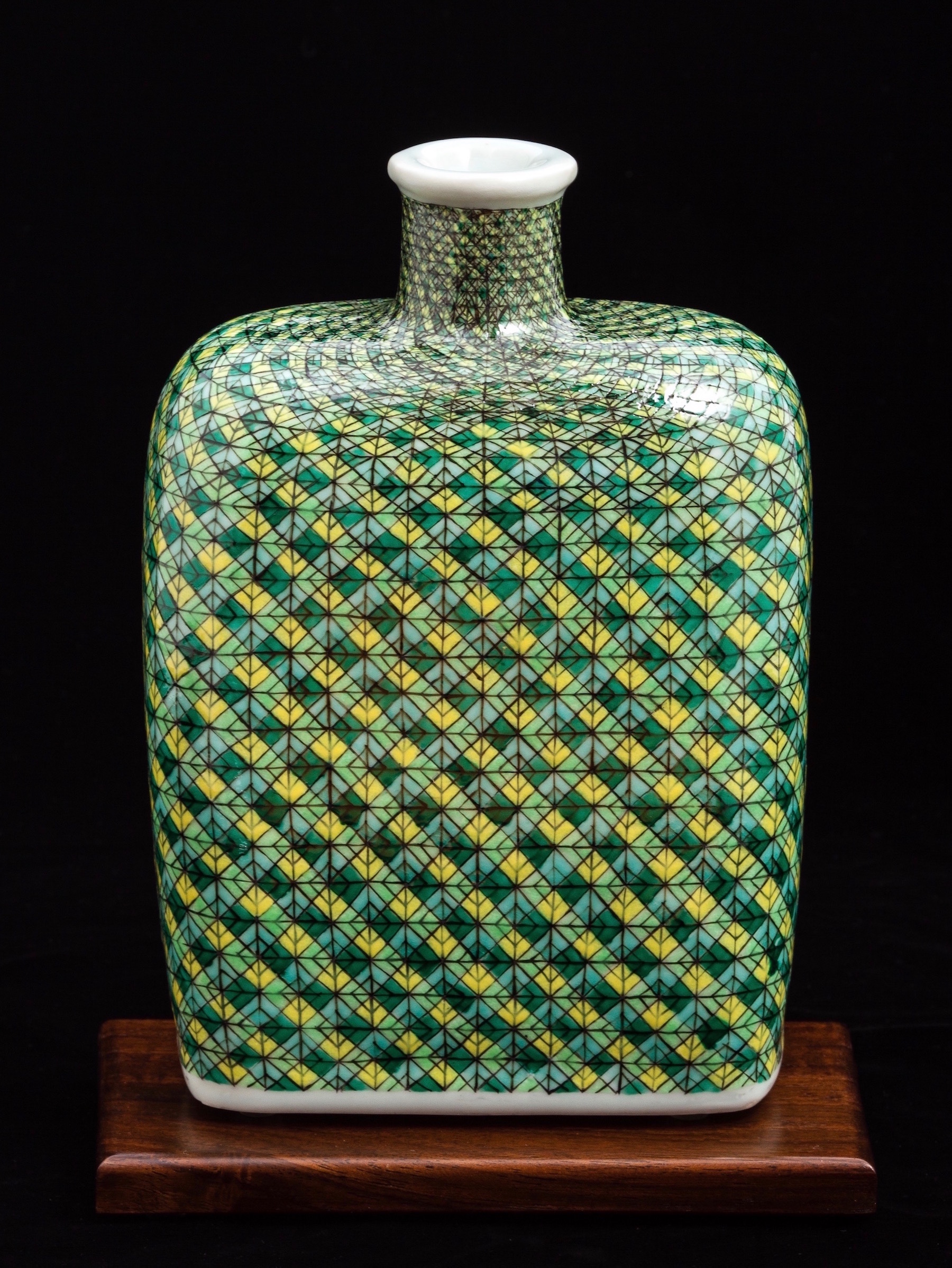 The Woven Bourbon Bottle was press-molded and gas reduction fired. Hand-painted gucai over-glaze enamels were electric fired. Enamels were built up abstractly to highlight the inherent luminosity and tactile qualities of the transparent over-glaze media.
