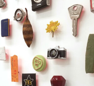 small representational objects in a halo on a white wall