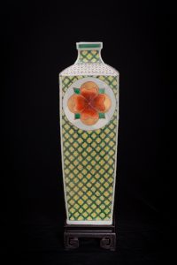 Vase with Flower Medallions was press-molded and fired cone 10 reduction. Traditional gucai over-glaze media and 24k German gold was hand-painted in layered applications and re-fired in multiple electric low temperature firings (6 firings). The work features the luminosity inherent to the media to render a sensual stately but joyful enriching presence.