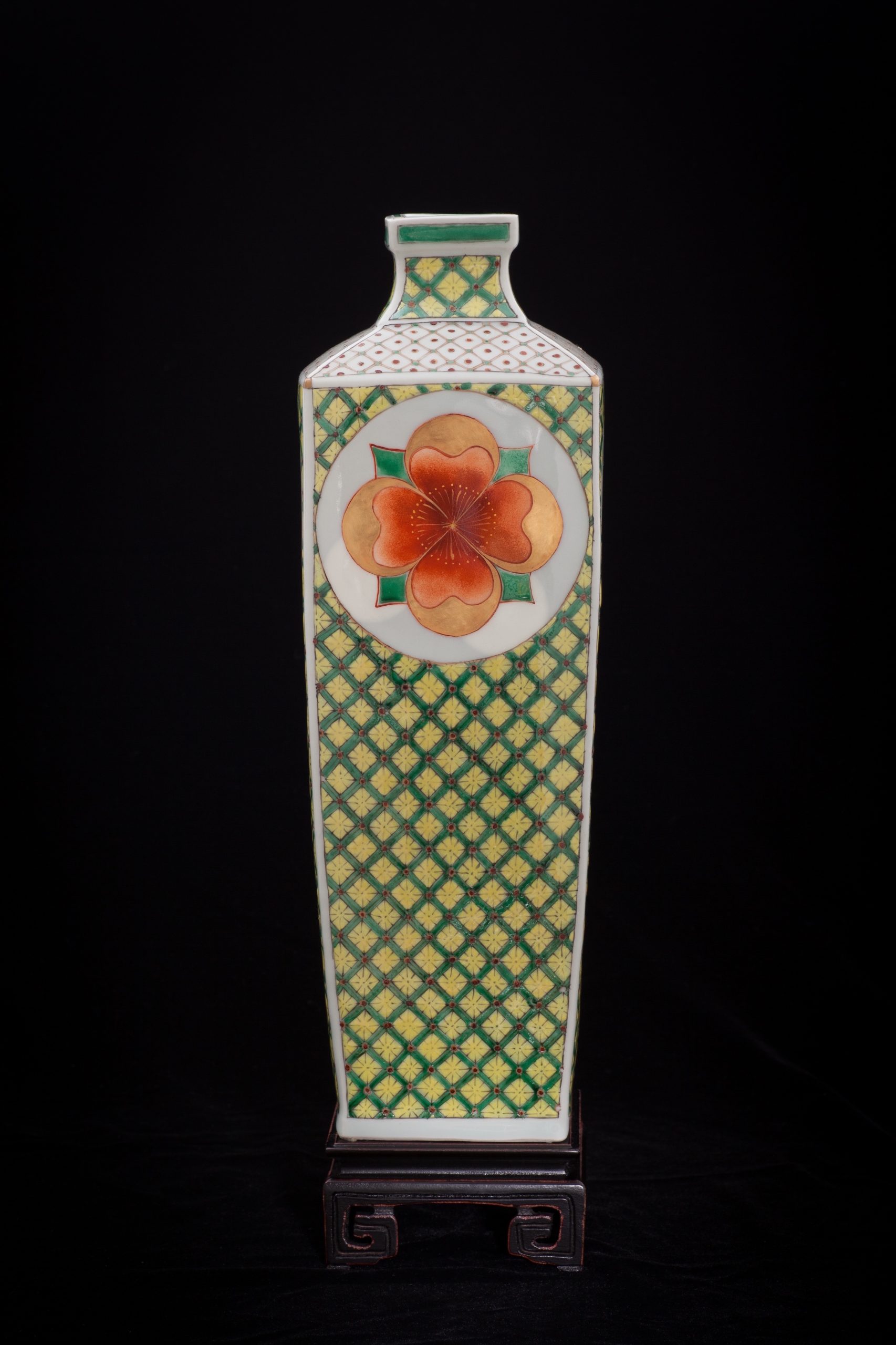 Vase with Flower Medallions was press-molded and fired cone 10 reduction. Traditional gucai over-glaze media and 24k German gold was hand-painted in layered applications and re-fired in multiple electric low temperature firings (6 firings). The work features the luminosity inherent to the media to render a sensual stately but joyful enriching presence.
