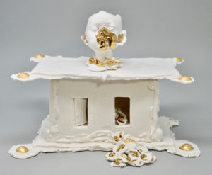 This reliquary  pays homage children who have died  from school shootings. It holds hundreds of hand pressed ears.  Resting on the child's collar are three  ear bones - the smallest bones in the human body.