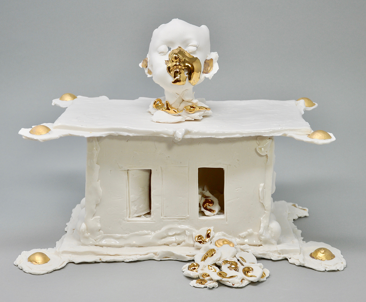 This reliquary  pays homage children who have died  from school shootings. It holds hundreds of hand pressed ears.  Resting on the child's collar are three  ear bones - the smallest bones in the human body.