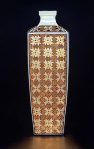 Two golds are applied to provoke luminosity through contrast in an earthy patina. The work is press-molded and features over-glaze enamels  (youhong red, fencai), 24 k Roman and German golds, and copper lustre. The piece is about yun - literally, an ochre-like substance found in the stream-beds of Tibet, but more broadly referring to places and objects with an enriching presence.