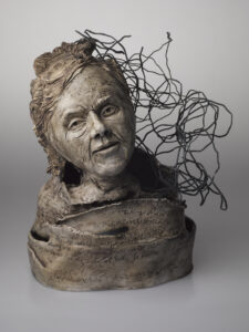 In this series including Lonely Girl Room 3400, clay and wires were used to illuminate memory issues related to Alzheimer’s disease through a gendered lens. Watching my mother navigate her remaining years while living with the disease coupled with statistics indicating among other things that women with dementia outnumber men two to one, created a sense of urgency in me to make a lot of them. Layers of color were applied using hazelnut mason stain and wax. Text was carved into this one including a poem about aging written by my sister along with quotes regarding dementia.  The room number refers to the one room women were reduced to living in while living out their last days in a nursing home.  It was also written into their clothes tags (reminiscent of kindergarten) yet, clothes were lost all the time and my mother had someone else's on many times.