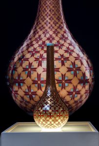 Hand-painted with over-glaze enamels (gucai) and 24k Roman and German golds featuring an original arrowhead design signifying bravery shining out without doubt. This pieces is a "high"  or imperial use of decoration in contrast to the earthy  media expression of Earth Warrior. 7 firings include 5 low temperature electric firings of media on celadon reduction fired glaze.