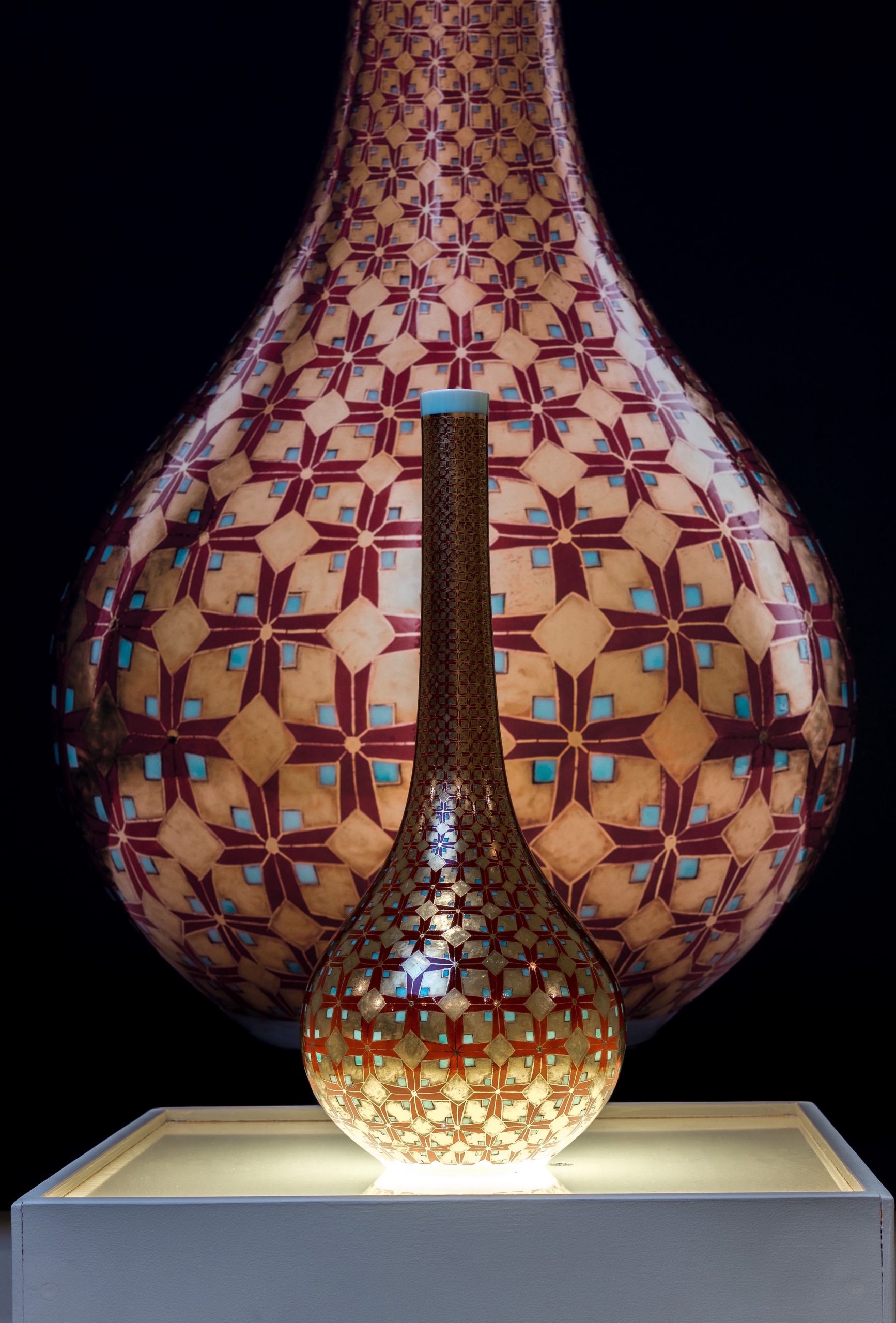 Hand-painted with over-glaze enamels (gucai) and 24k Roman and German golds featuring an original arrowhead design signifying bravery shining out without doubt. This pieces is a "high"  or imperial use of decoration in contrast to the earthy  media expression of Earth Warrior. 7 firings include 5 low temperature electric firings of media on celadon reduction fired glaze.