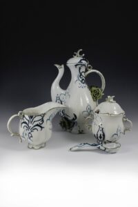 Part of a full service coffee set. Coffee/tea pot, interchangeable pour over top, cream and sugar set with spoon, four coffee cups and saucers.
