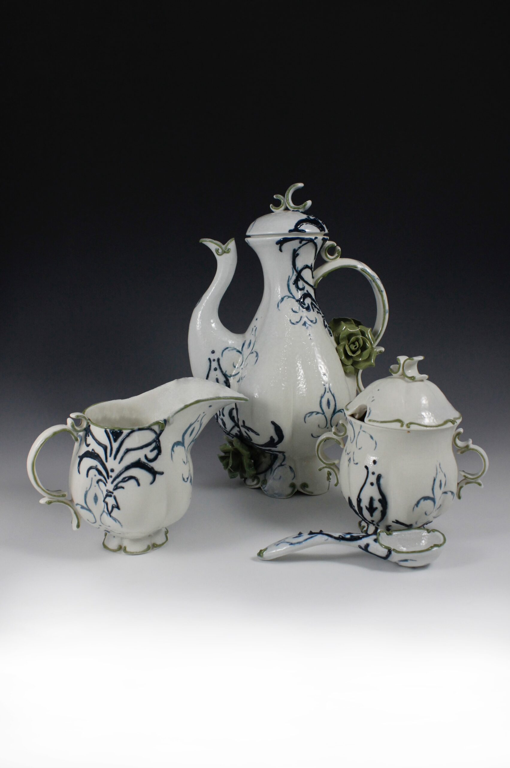 Part of a full service coffee set. Coffee/tea pot, interchangeable pour over top, cream and sugar set with spoon, four coffee cups and saucers.