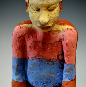 close view of figure, with painting reflected onto it. About isolation during Covid19.