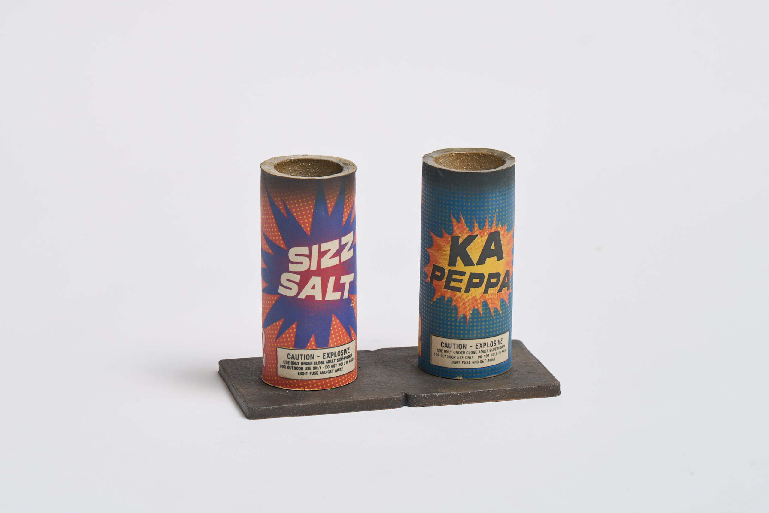 Screenprinted underglaze on white stoneware. Both are functional salt and pepper shakers