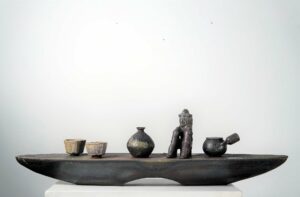 Artifacts are objects that are made by humans which contain cultural, and historical context.
I created the work that represents my personal history between Korea and the US by carefully laying them on top of the horizontal “Vessel” shaped pedestal which is the medium of transportation that connects two different countries. The forms are the ones I brought from my time in Korea and I sculpted them in the US.