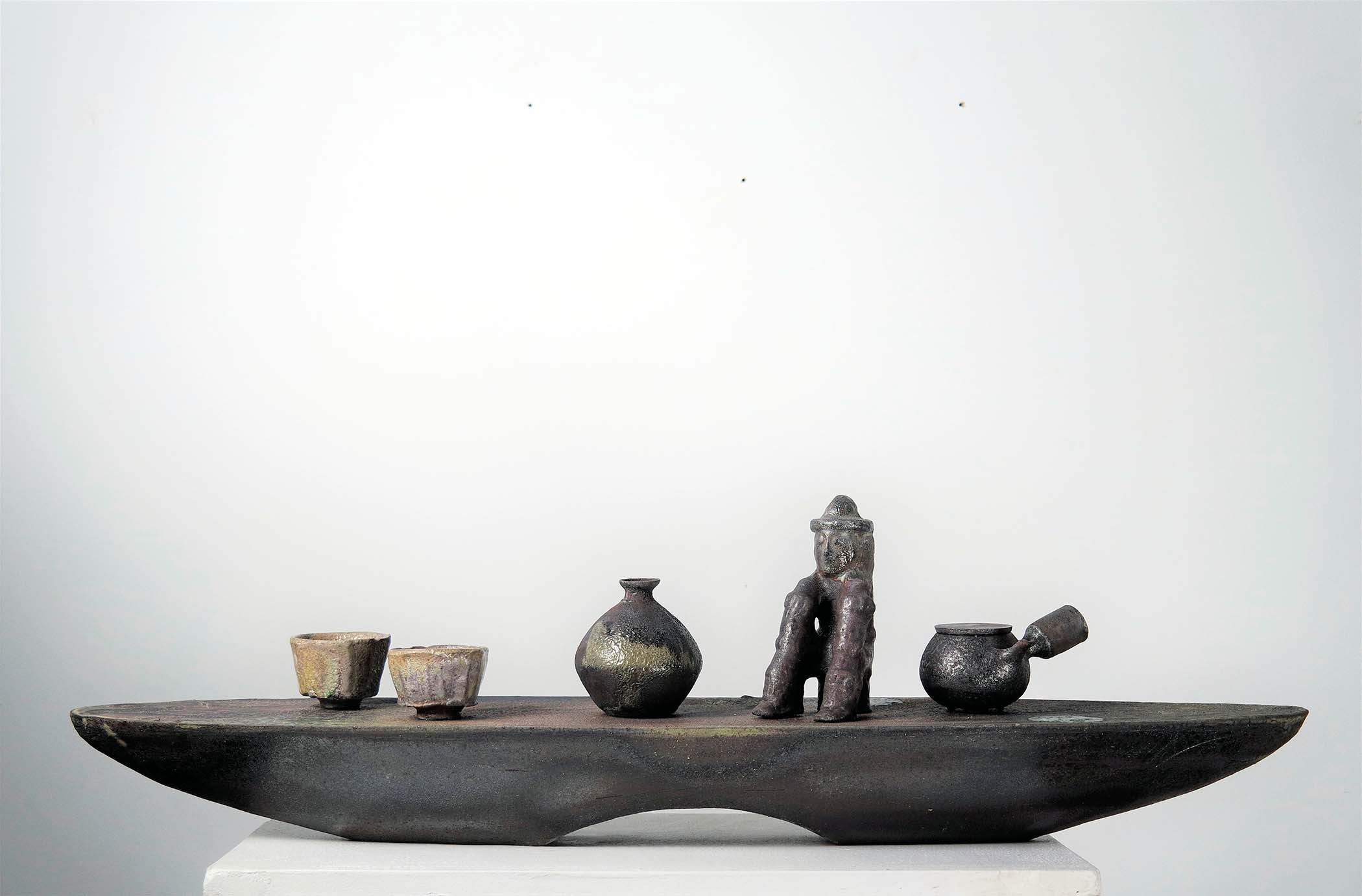 Artifacts are objects that are made by humans which contain cultural, and historical context.
I created the work that represents my personal history between Korea and the US by carefully laying them on top of the horizontal “Vessel” shaped pedestal which is the medium of transportation that connects two different countries. The forms are the ones I brought from my time in Korea and I sculpted them in the US.