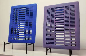 "Birthright" consists of two similar forms, each with differences that are surface deep. Both are blue on one side & purple on the reverse, showing a division between them based on how they are viewed. One is elevated for no apparent reason, reflecting on social privilege & questioning inequality.