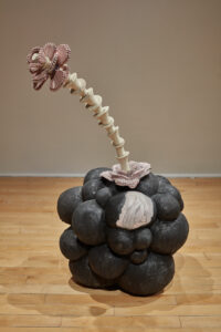 Glazed, low-fire earthenware biomorphic form from which the unglazed and underglazed mid-range porcelain 'flesh flower' stalk projects