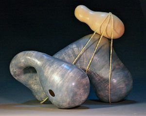 The surface is colored terra sigillata that has been burnished.  The mixed media aspect of this work is crocheted string.