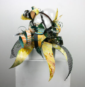 Hand blown glass with repurposed aluminum and plastic that has been hand painted.