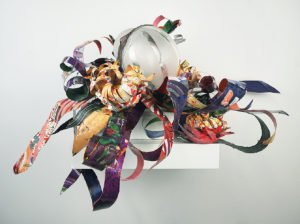 Hand blown glass that a design was hand created and sandblasted into the surface combined with repurposed aluminum and plastic that has been hand painted.