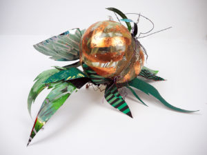 Hand blown glass with copper leaf and repurposed aluminum and plastic that has been hand painted.