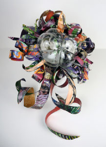 Hand blown glass with repurposed aluminum and plastic that has been hand painted.