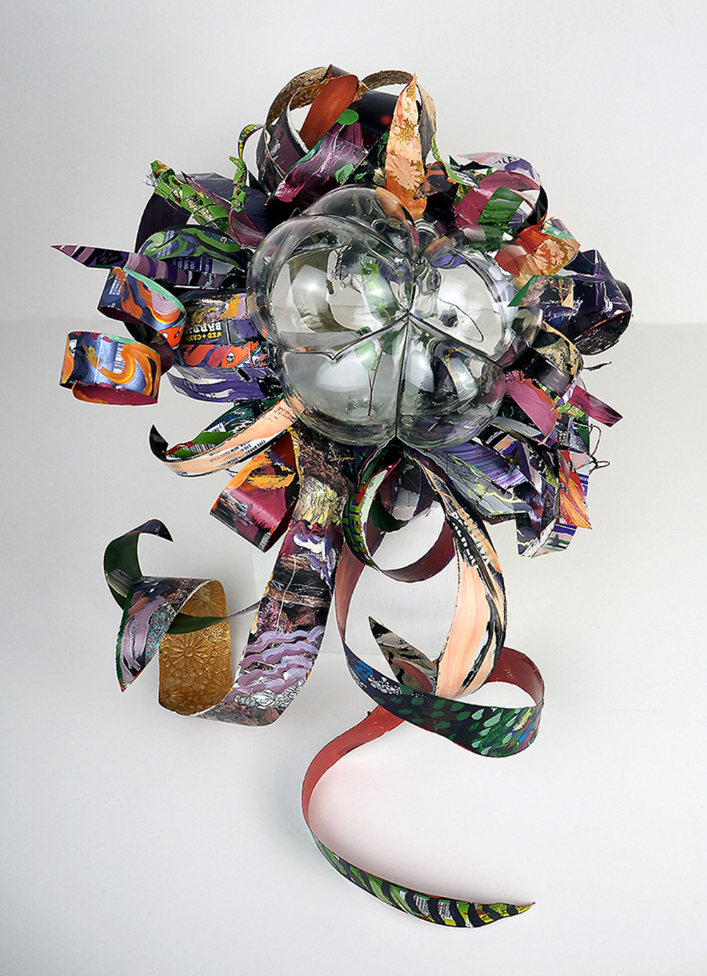Hand blown glass with repurposed aluminum and plastic that has been hand painted.