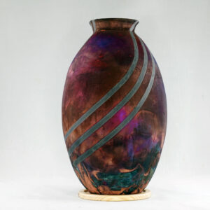 The full copper matte glaze provides a striking finish to the vase, making it an instant contrast to any interior. With an iridescent splash of metallic-like colors and unique patterns covering the vase’s body after Raku firing, no two pieces are the same.