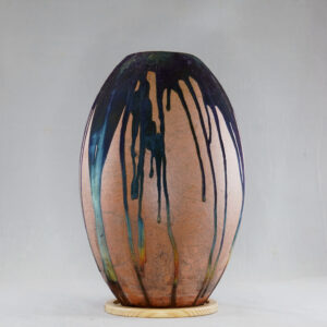 The copper matte glaze is only applied to a portion of the vase, resulting in its body being half-covered in a beautiful unexpected rainbow-like metallic finish after Raku firing. Every vase is guaranteed to be one of its kind, almost effortlessly accenting the very shape of the vase.