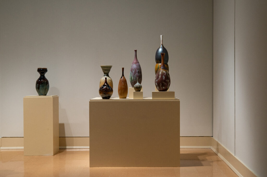 This is a gallery shot of the exhibition "Calling Home- 2025 Mississippi Invitational", a group invitational exhibition curated by TK Smith. This image is a view of my piece "Migration Across Continents", an installation of thrown and carved highfired porcelain.