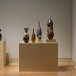 This is a gallery shot of the exhibition "Calling Home- 2025 Mississippi Invitational", a group invitational exhibition curated by TK Smith. This image is a view of my piece "Migration Across Continents", an installation of thrown and carved highfired porcelain.