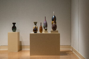 This is a gallery shot of the exhibition "Calling Home- 2025 Mississippi Invitational", a group invitational exhibition curated by TK Smith. This image is a view of my piece "Migration Across Continents", an installation of thrown and carved highfired porcelain.