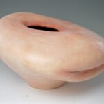 The surface of the form consists of pigmented silicone and medical sutures.