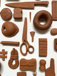 terra cotta objects on a white wall