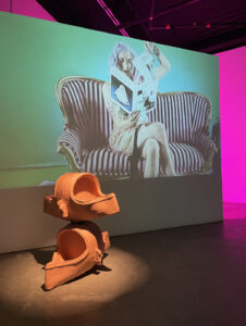2021, terracotta, video 

This urinal, of which there are many, since the original doesn’t exist anymore, has become a symbol for the birth of conceptualism. The act of a gender queer body tearing out pages of a book about Duchamp above a frankensteined (queered) version of his urinal grounds the work within the artworld. Rejecting its lineage, speaking to the new generation of artists that are on the rise, that reject and understand the domination of the artworld by the masculine,  straight, and rich.