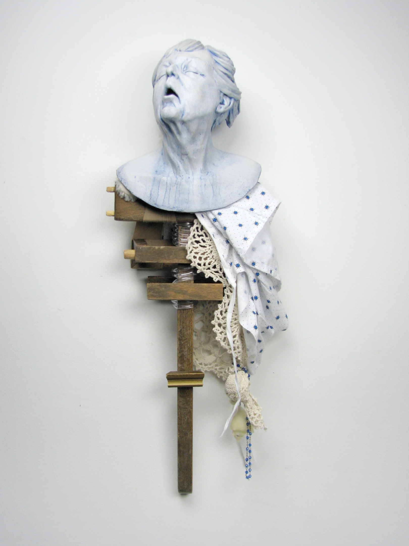 Full materials list: Earthenware, dining room chair, handmade doily, hospital gown, teddy bear, oxygen tubing, underglaze, wax