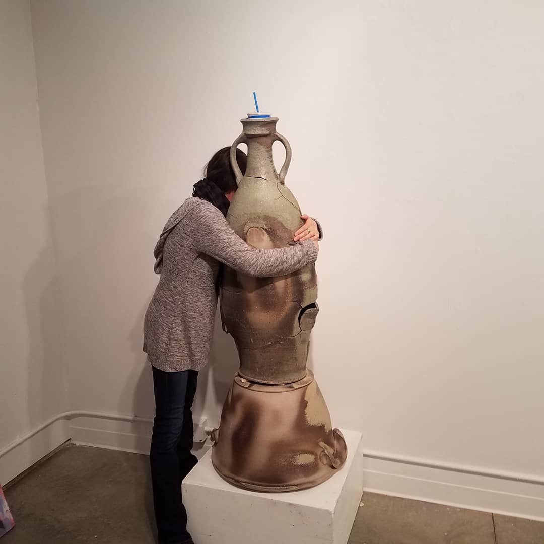 I really enjoy this photo of my friend Christina giving in to her urge to hug my piece.