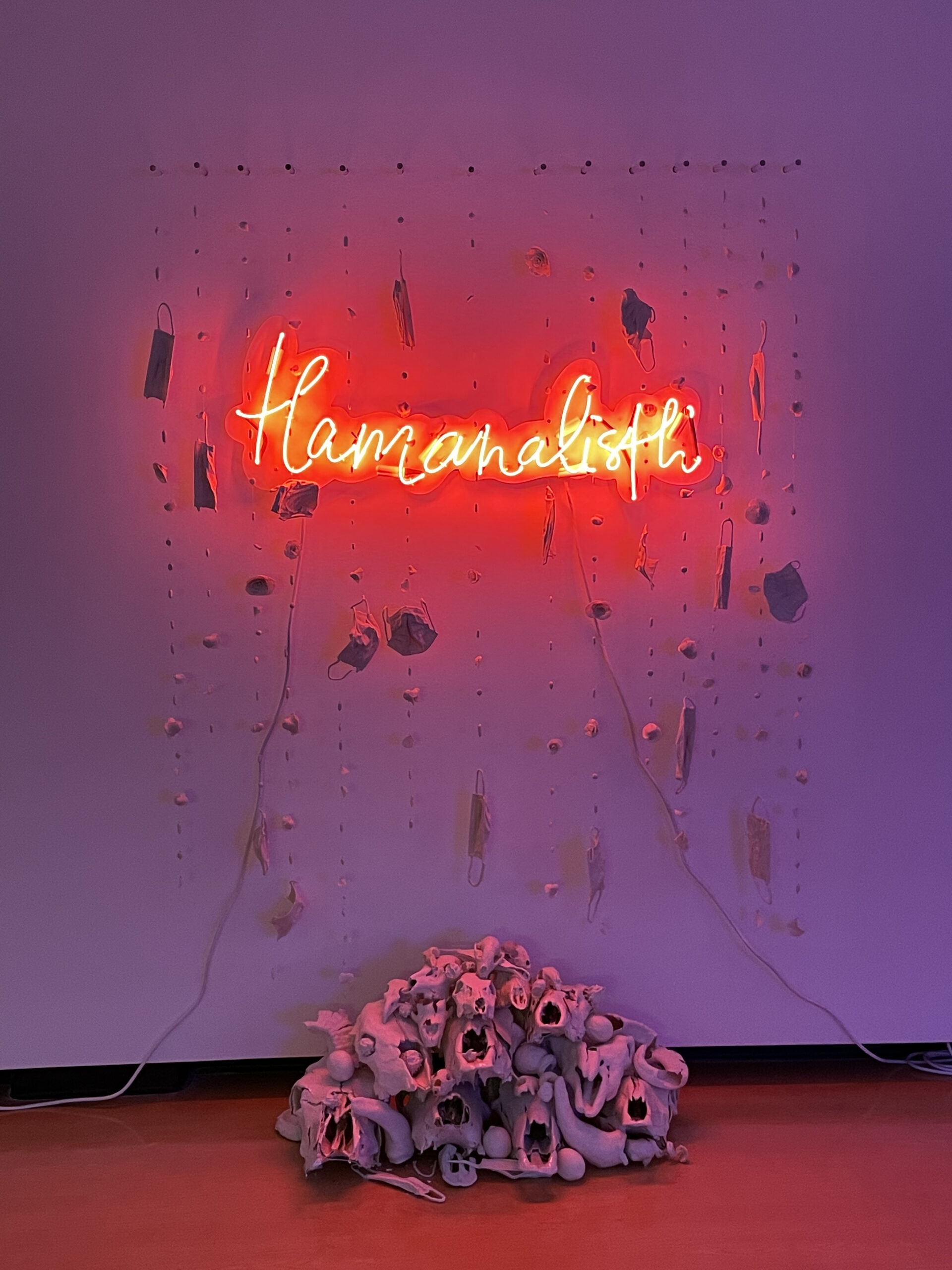 porcelain, neon, plexi: thread red neon text, loose porcelain 'curtain' of pills, flowers, and masks, flowing into pyramid of porcelain dipped skulls and thistles 
Tlamanalisti is the Nahuatl (Uto-Aztecan) word for the ritual of sacrifice. This piece refers to the frequent messaging that vulnerable groups should ‘be sacrificed’ during the pandemic in exchanged for a return to normalcy.